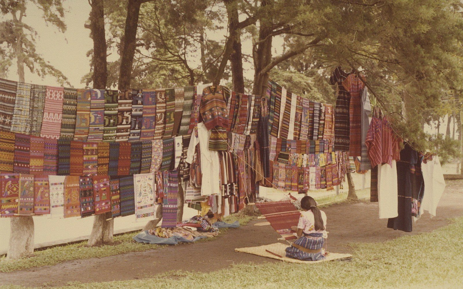 A backstrap loom strung mid-weave with dyed thread