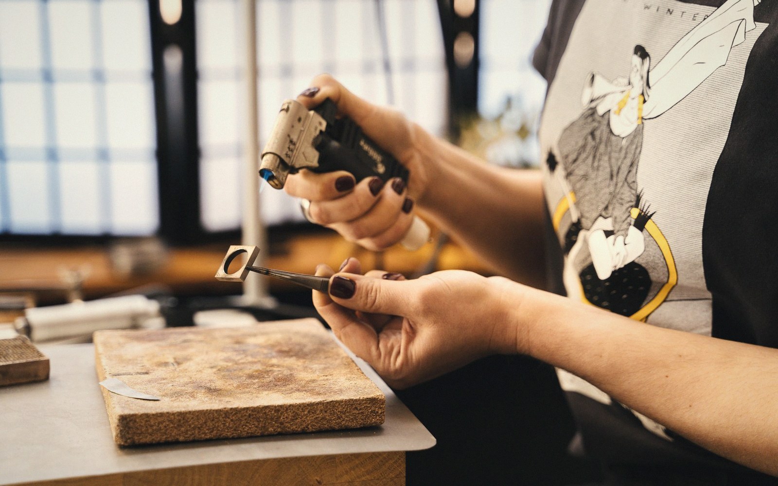 A silversmith’s bench with small tools laid out